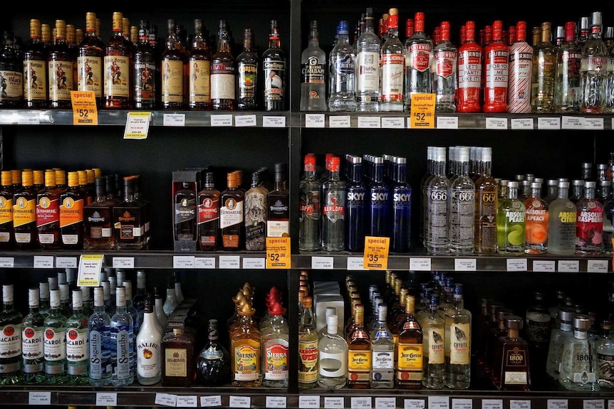 Shelves of alcohol in a bottle shop.