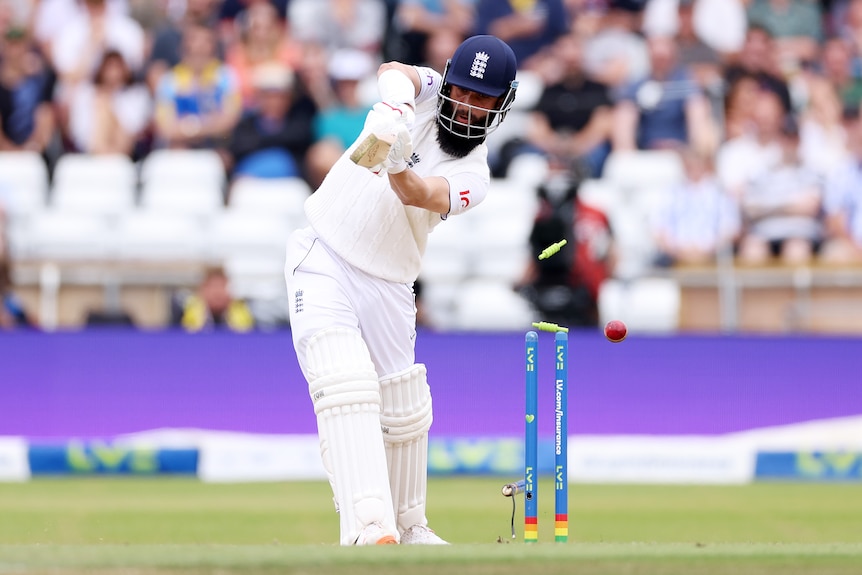 England batter Moeen Ali's stumps are broken as he completes a cricket shot during an Ashes Test.