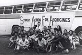 A black and white photo of the Freedom Riders and their bus in 1965
