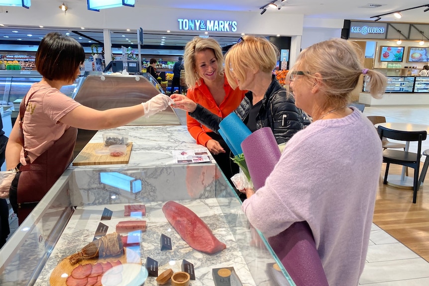 Customers are served at a fishmongers' store.