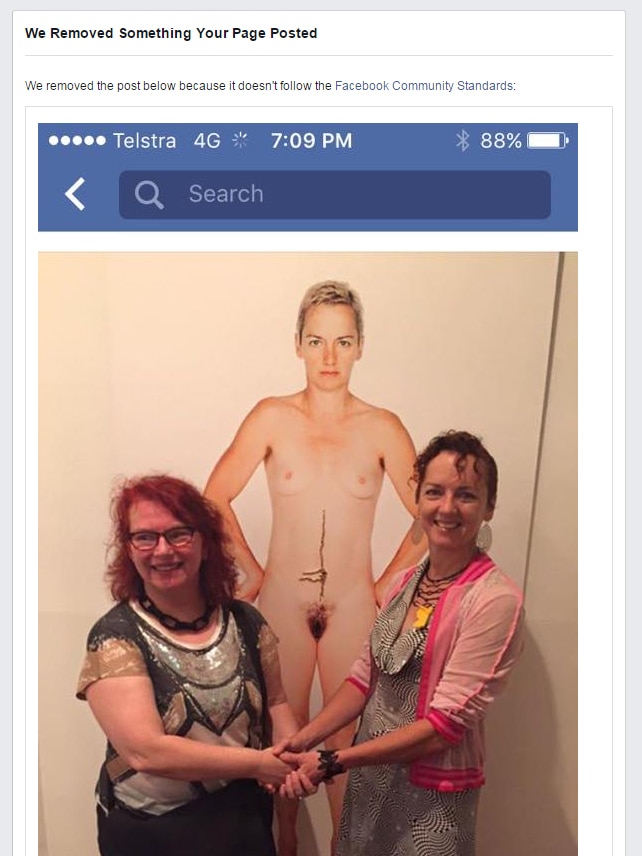 Artist Deborah Kelly and subject Simone O'Brien stand in front of a naked portrait of Ms O'Brien
