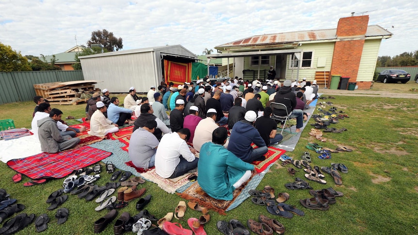 Muslims pray outside the Albury-Wodonga Islamic community centre