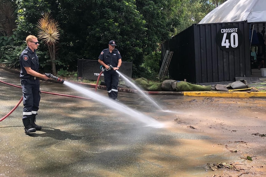 Fire officers hosing down driveway