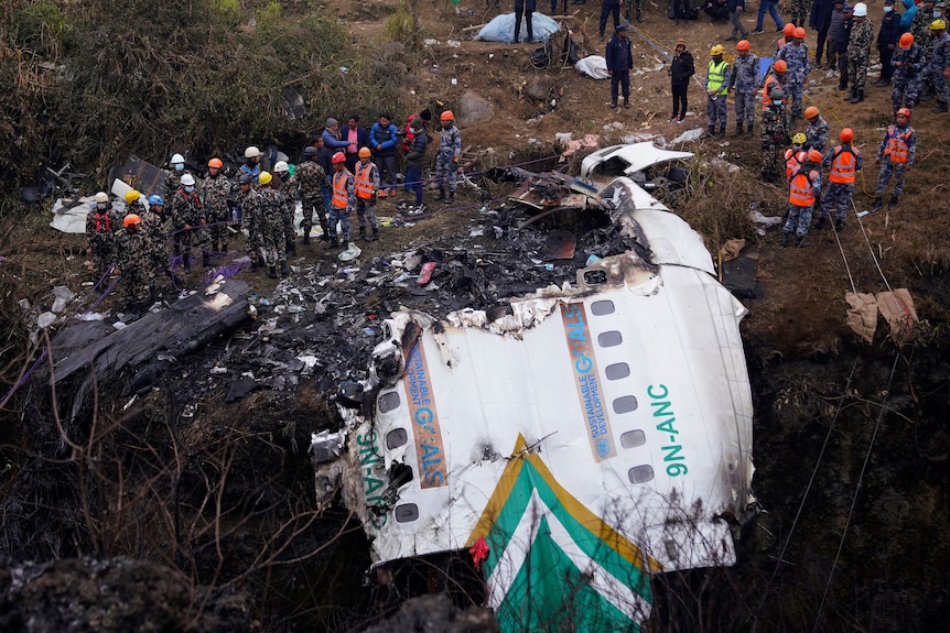 Rescuers scour the crash site of a Yeti Airlines passenger plane in Pokhara, Nepal, on Monday, January 16, 2023.