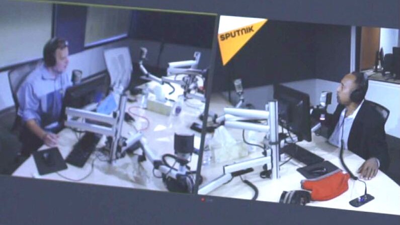 Two broadcaster on Sputnik Radio as seem through an editing split screen