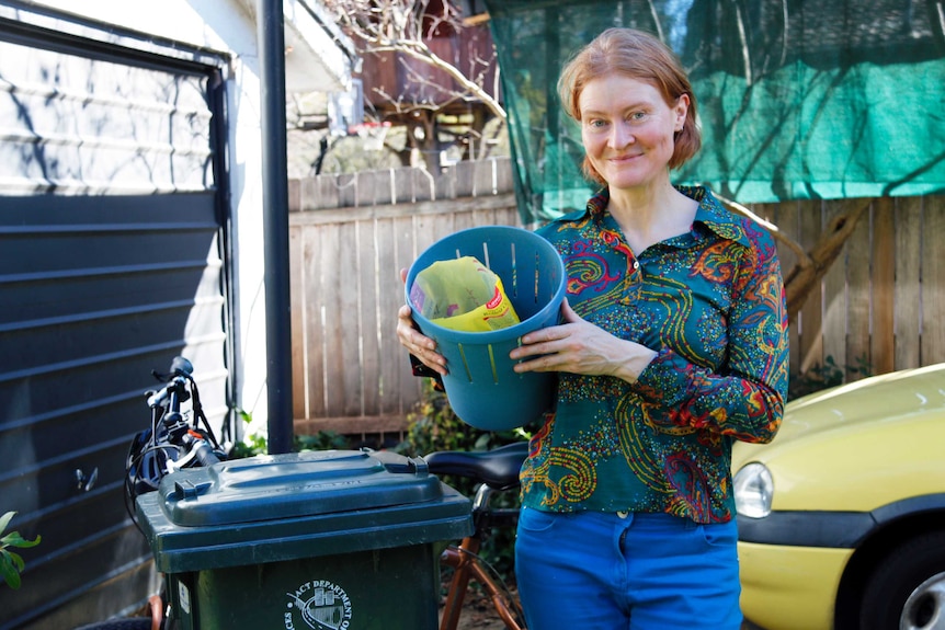 Helen Way, of Canberra, proudly holds a small bin containing a week's worth of waste.