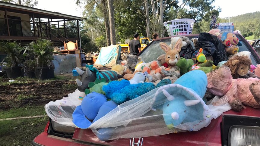 Belongings outside a flooded Luscombe home