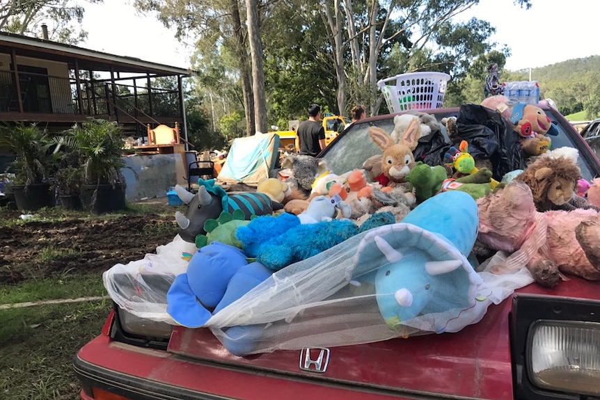 Belongings outside a flooded Luscombe home