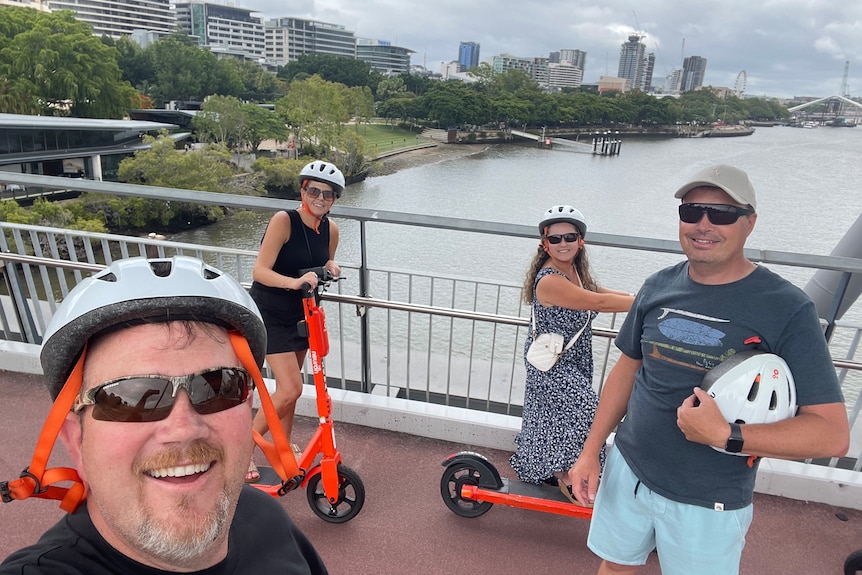 Two couples on a bridge over the Brisbane River.