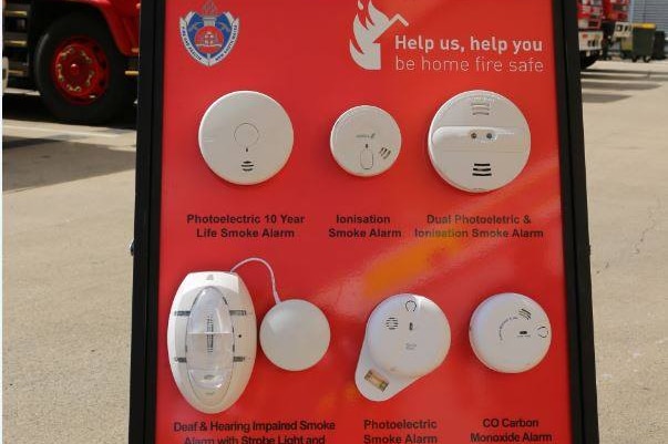 Different kinds of smoke alarms displayed at a fire station