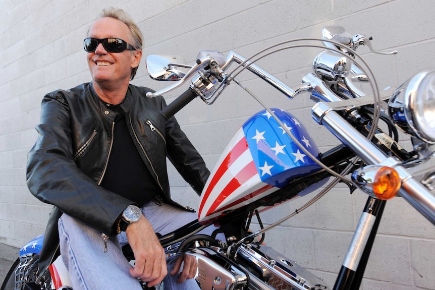 Peter Fonda sitting on a motorcycle