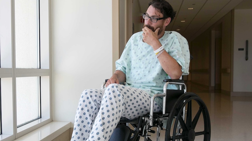 Mathias Steinhuber sits in a wheelchair and stares out the window pensively