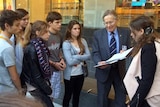 French teenagers meet with Ron Purssey, the son of a WWI digger outside the ABC building in Brisbane