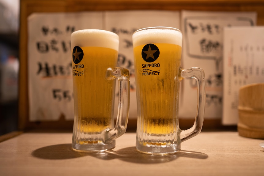 Two big frosty glasses of Sapporo beer