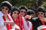 A carload of Elvis impersonators drive through the centre of Parkes during the Elvis Festival.