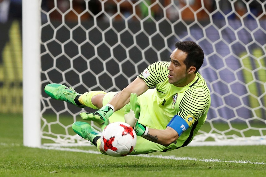 Chile's Claudio Bravo saves from Portugal's Nani to win the penalty shootout in the Confederations Cup semi-final.