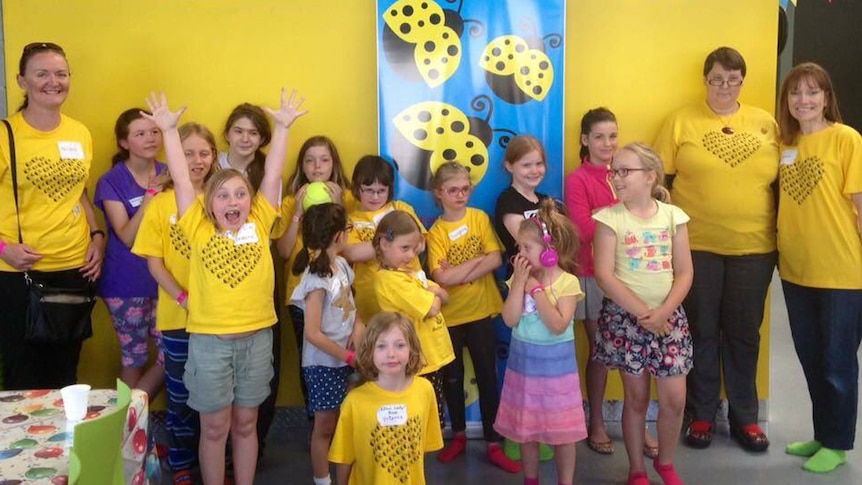 Girls wearing yellow at a playground.