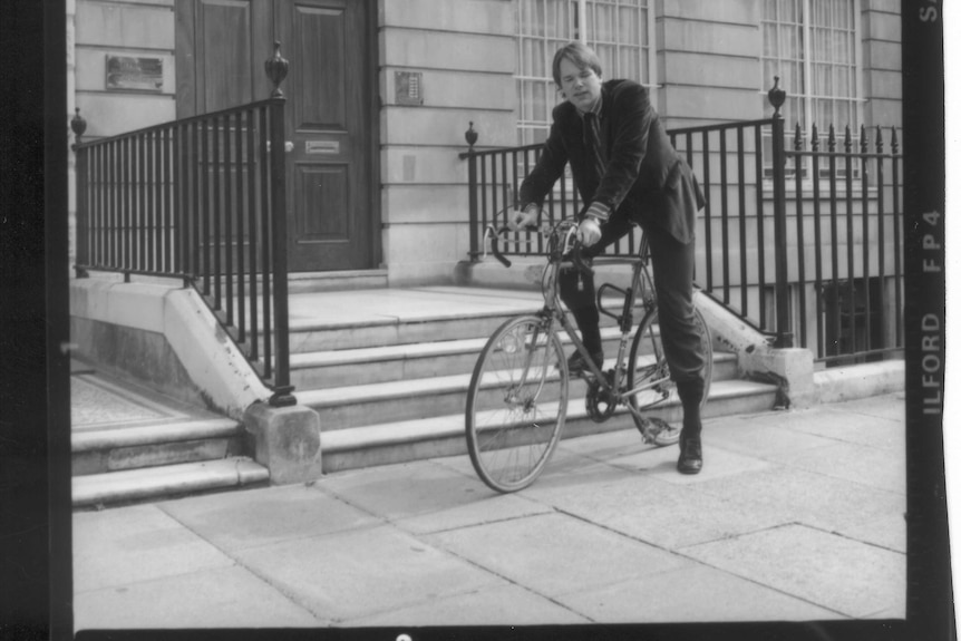 Mark Colvin on a bicycle in London