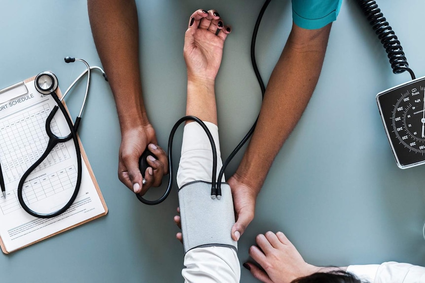 Doctor checks a patients blood pressure.