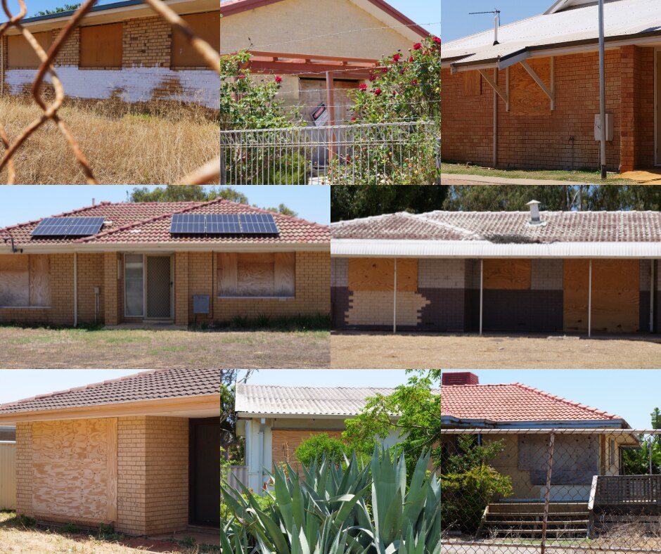 Eight different houses with windows boarded up.