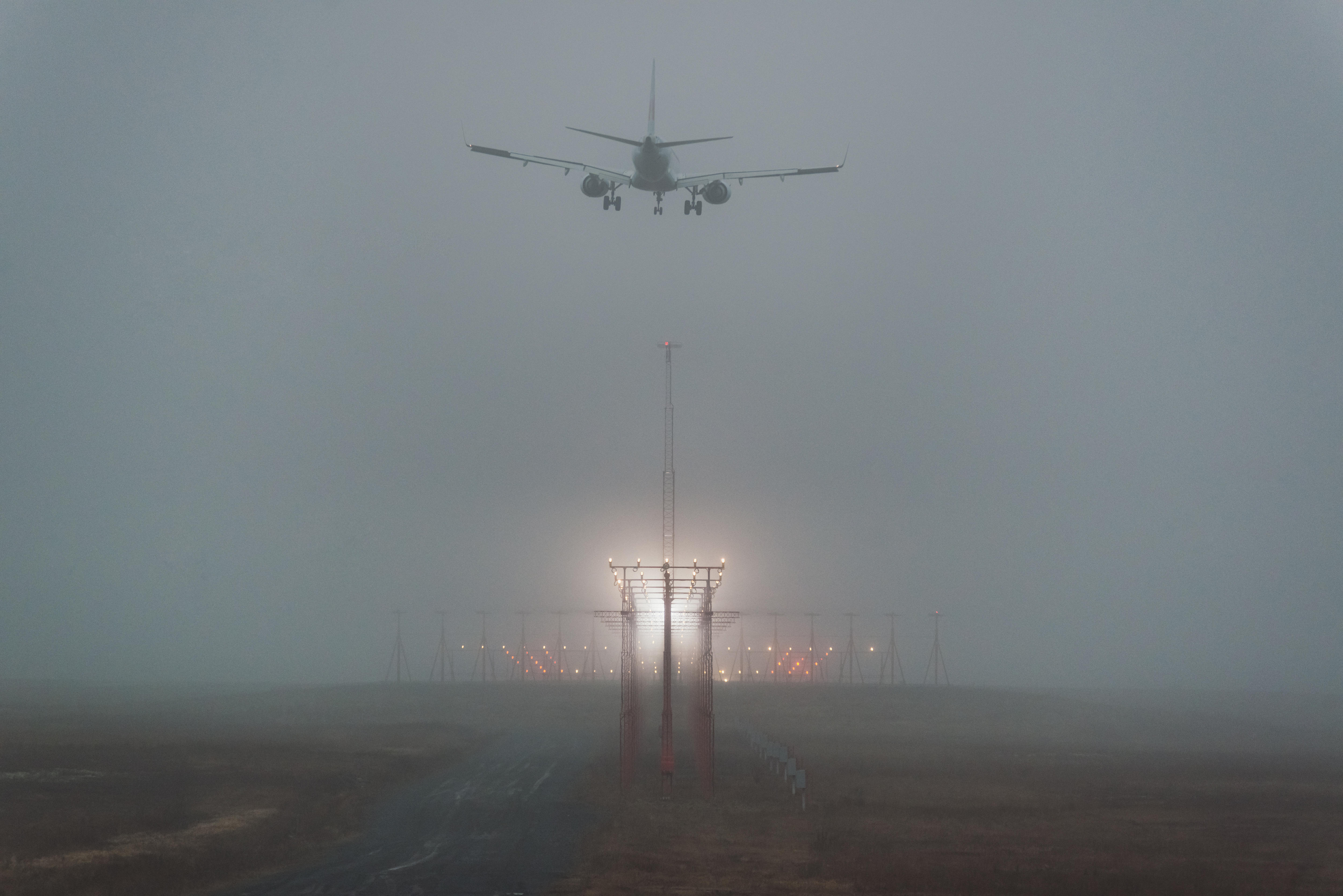 A passenger jet on final approach in heavy fog