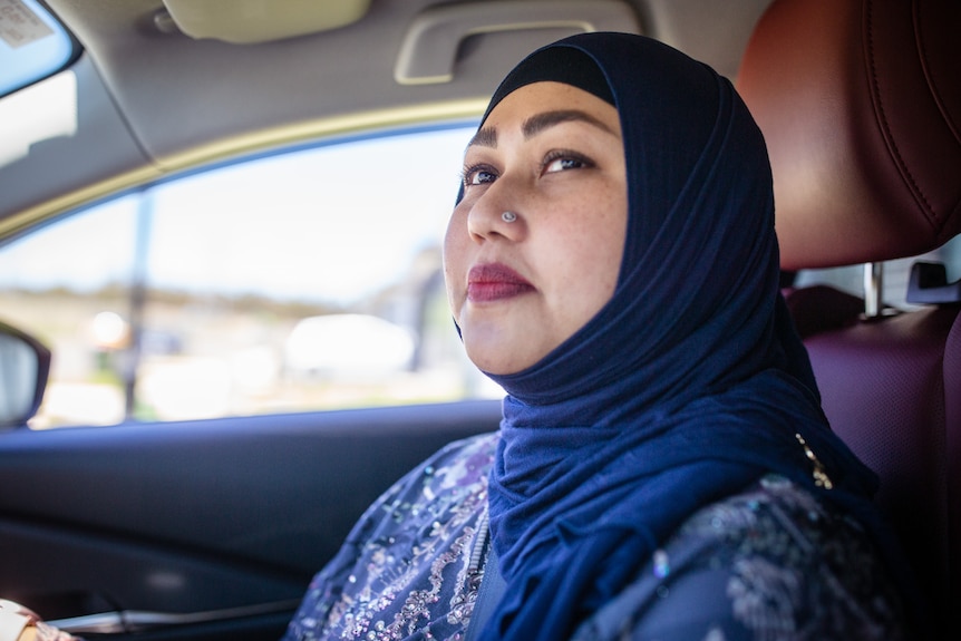 Woman in hijab driving car