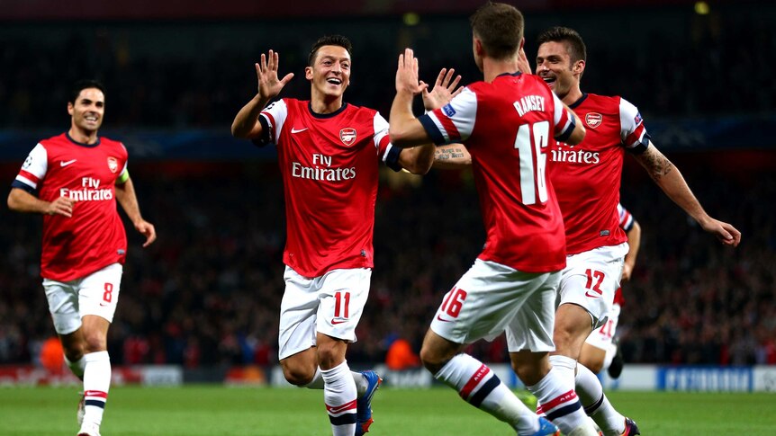Mesut Ozil of Arsenal is congratulated after scoring the opening goal against Napoli.