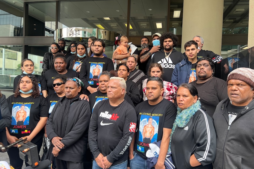 Family and supporters wearing black t-shirts depicting Jomen as an angel