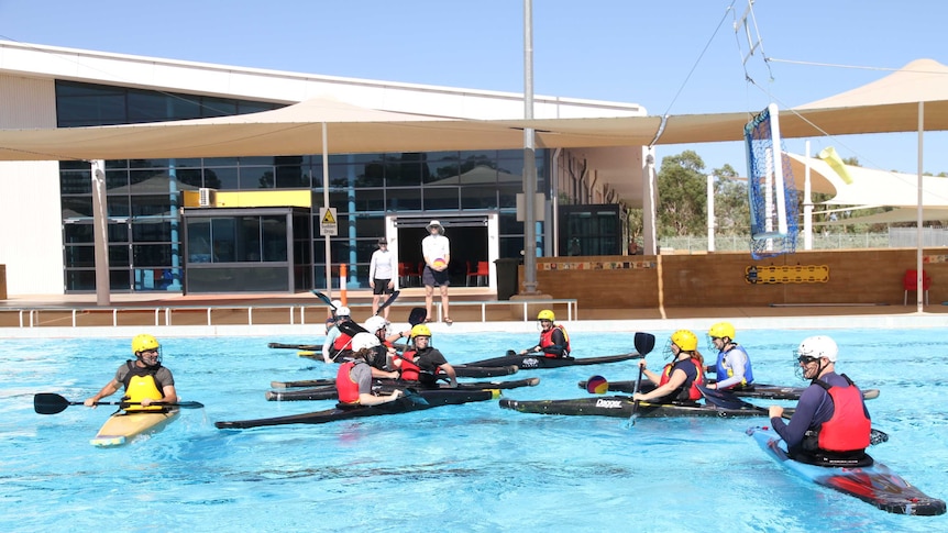 Canoe polo players go head-to-head in the Alice Springs pool.
