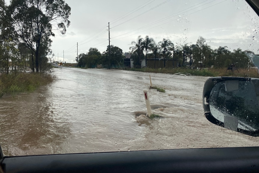 Water over road after storm at Munbilla, west of Ipswich.