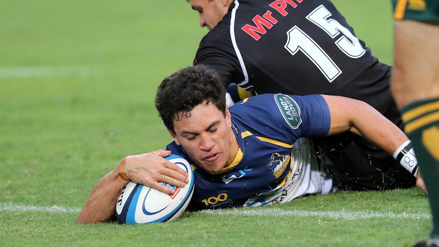 The Brumbies' Matt Toomua scores his side's third try against the Sharks in Durban.