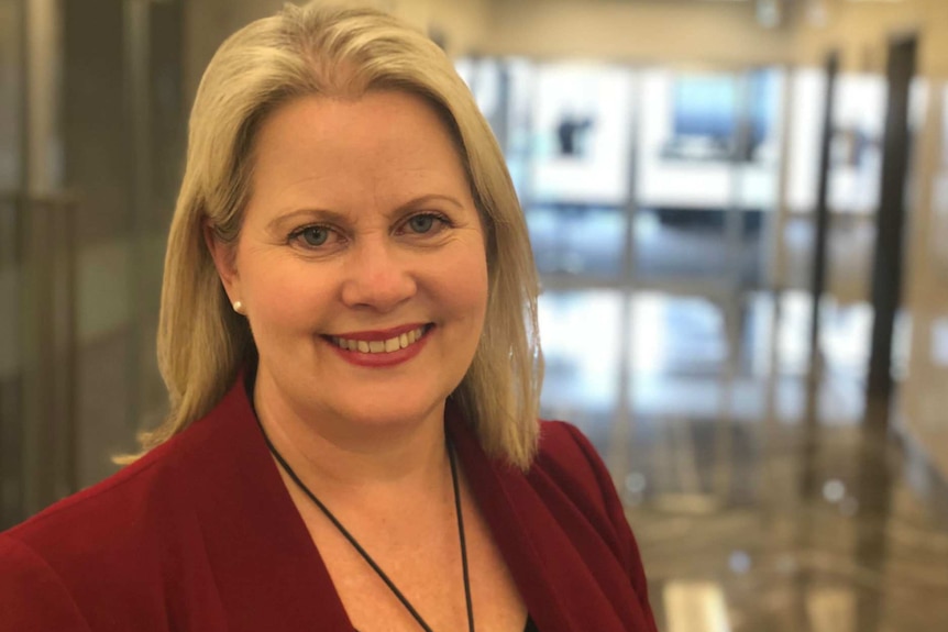 Trish White smiles at the camera in a portrait.