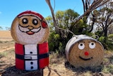 two hay bales that have been turned into santa and a reindeer