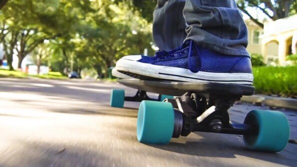 person with blue sneakers riding a blue skateboard