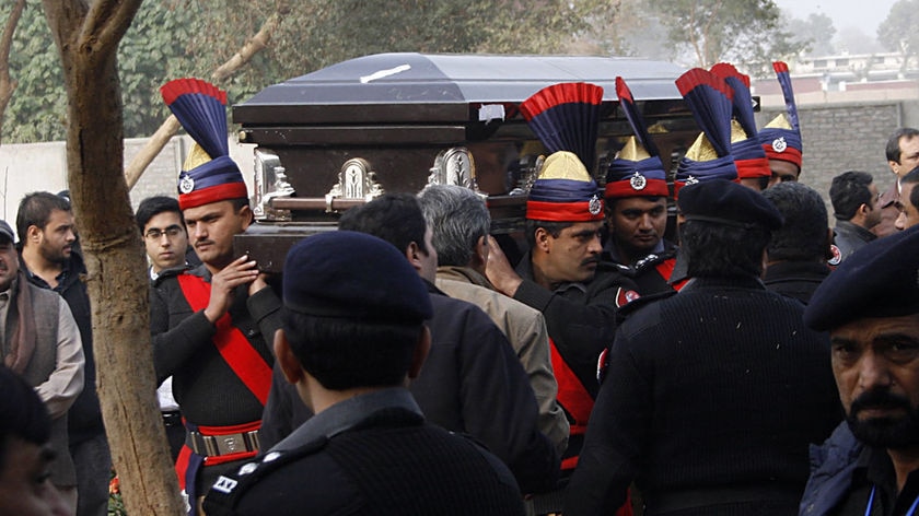 Police carry the coffin of Pakistan governor Salman Taseer