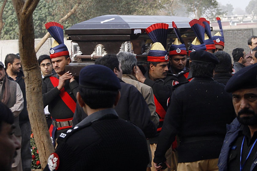 Police carry the coffin of Pakistan governor Salman Taseer