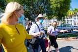 Lawyer Jon Tippett QC walking away from the NT Supreme Court flanked by reporters.