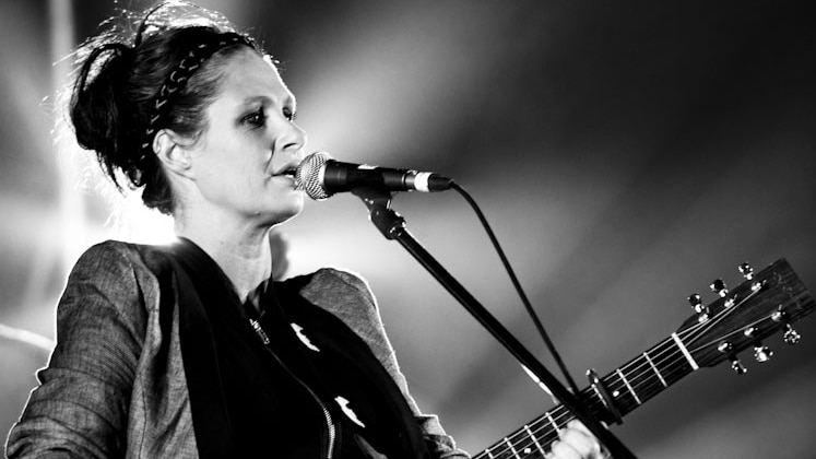 singer Kasey chambers at microphone, black and white photo