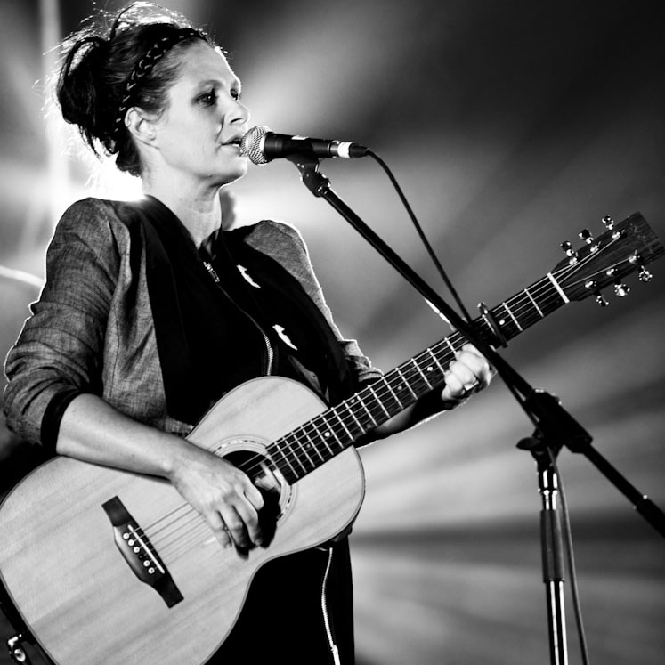 singer Kasey chambers at microphone, black and white photo