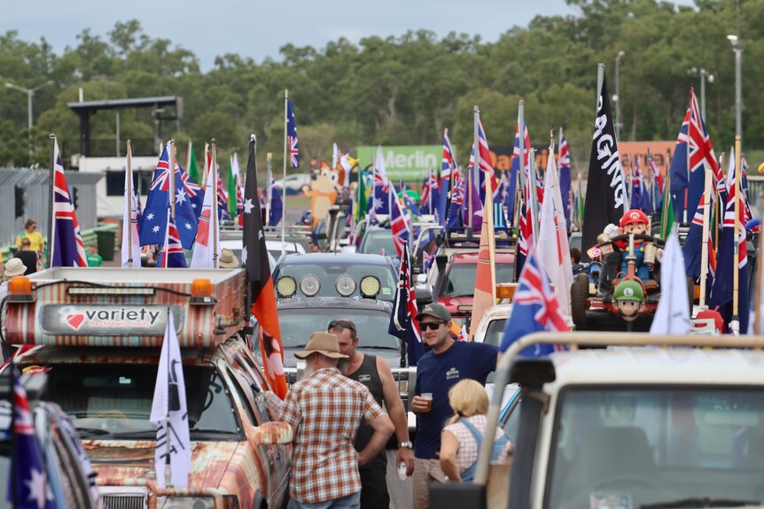 a line up of utes decked out with australian flags