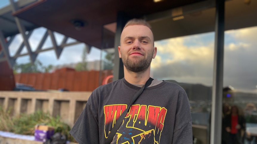A man wears a Wu-Tang Clan t-shirt