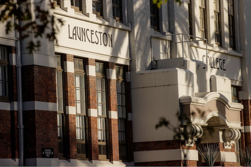 A sign outside a white building reads: Launceston college