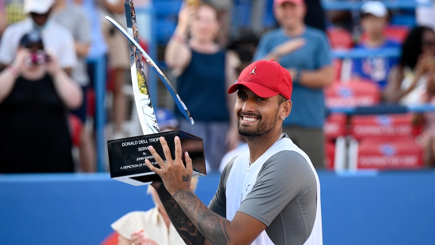 Nick Kyrgios poses and smiles with the Washington Open trophy