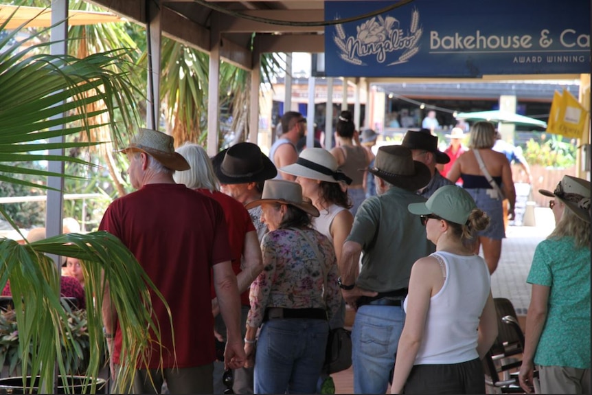 Crowds of people walk along Exmouth's main street.