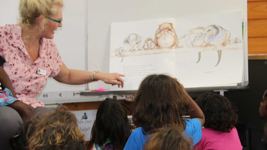 Young Aboriginal students listen to a teacher at a Darwin High School.