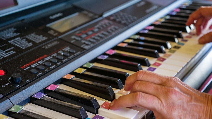 A close-up of hands playing a keyboard.