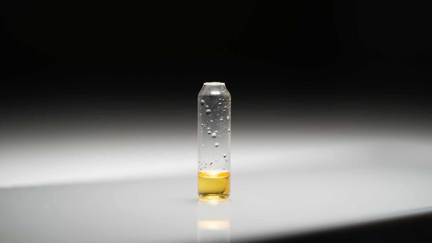 a yellow substance in small vial