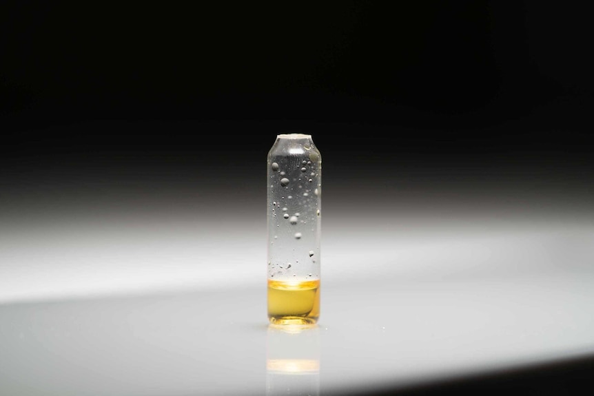 a yellow substance in small vial