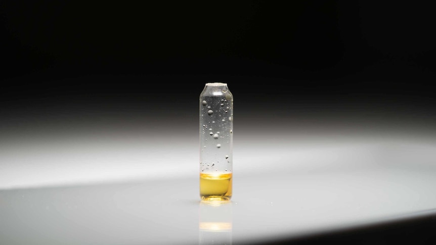 a yellow substance in small vial