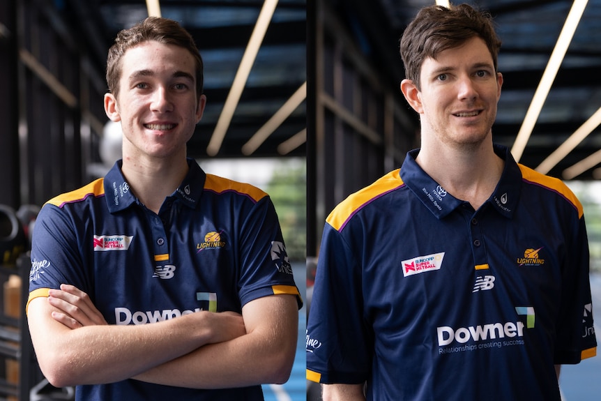Two men pose for a photo in their navy and yellow Lightning tops, the one on the left has his arms crossed